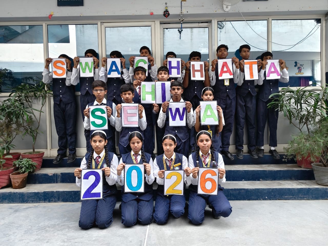 'Swachhata Hi Sewa 2026' — students spell out the campaign